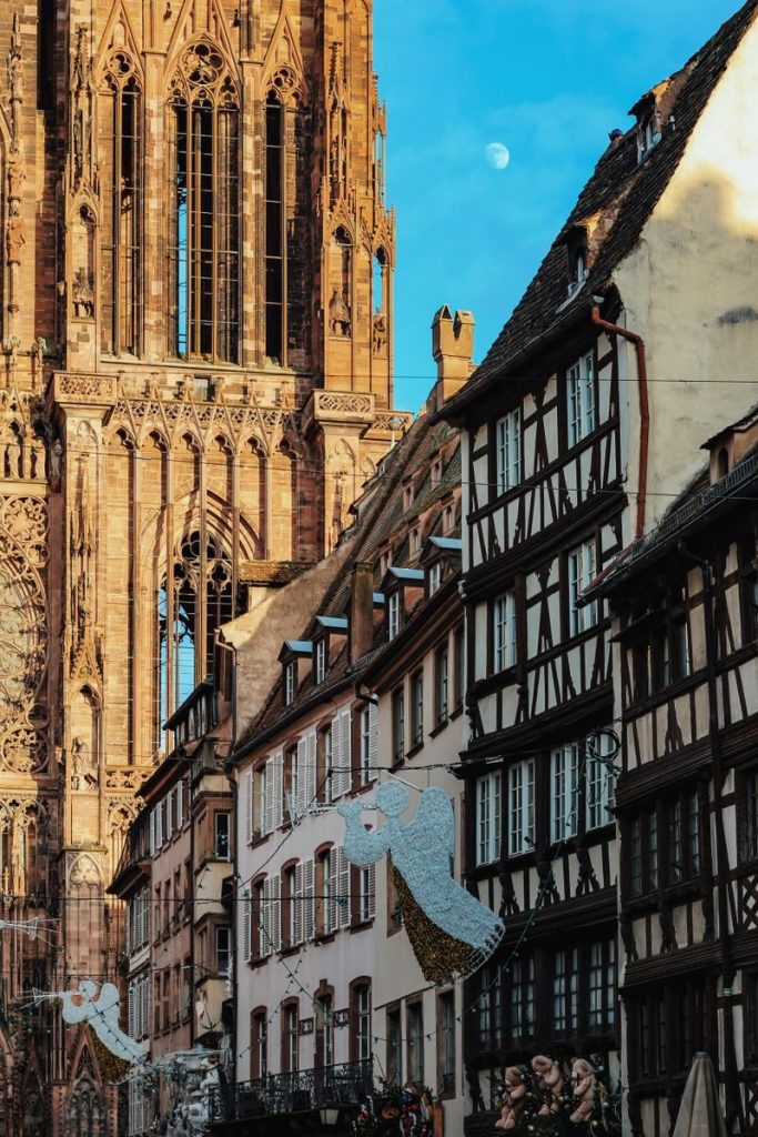 Charming view of Strasbourg Cathedral against a historic street at dusk.